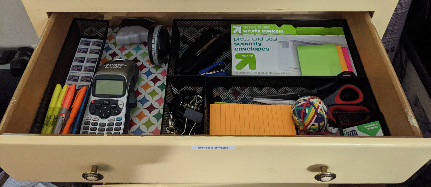 An drawer of organized office supplies